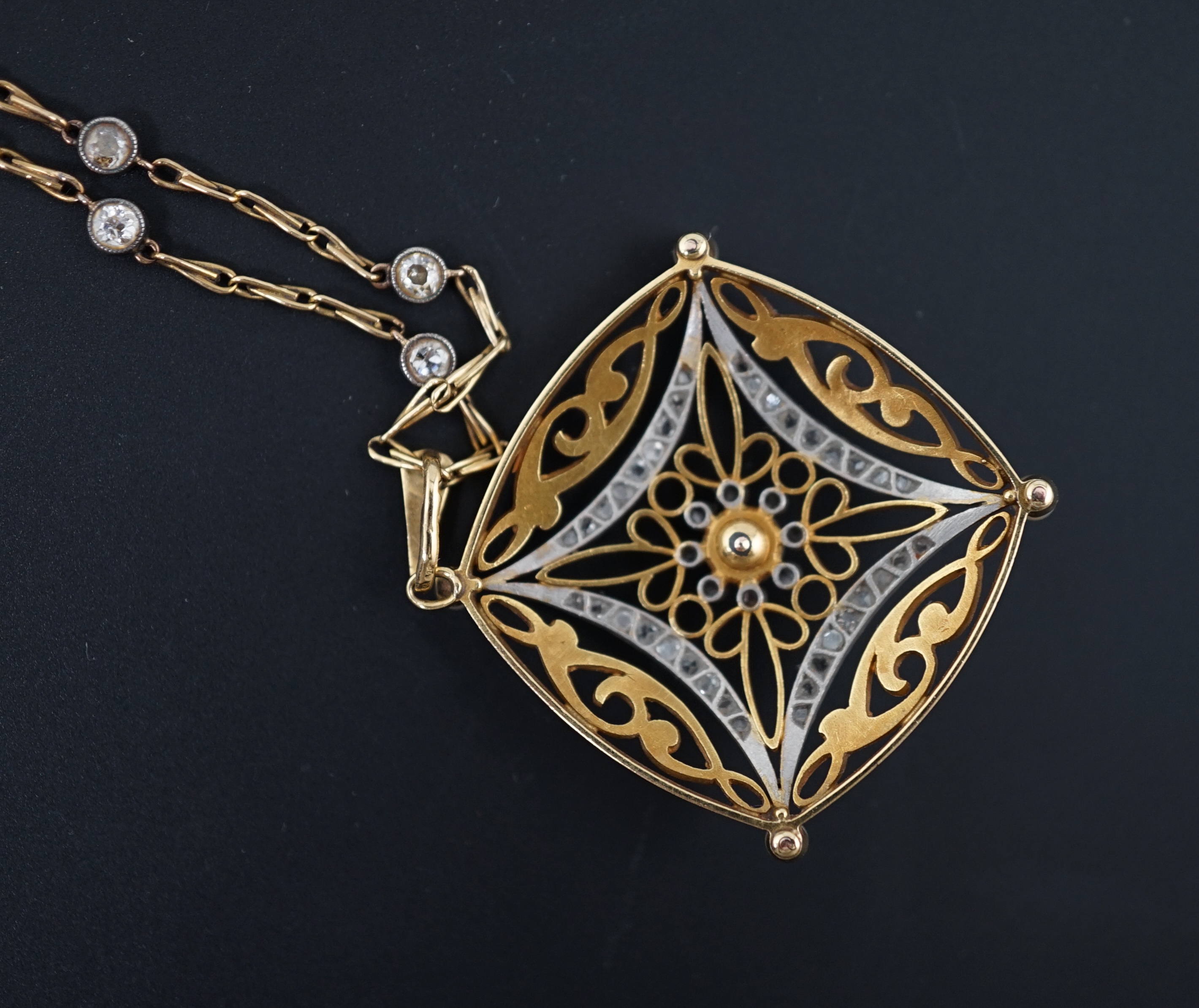 A French Belle Epoque pierced 18k gold, seed pearl and rose cut diamond set pendant, on a French 18k gold and diamond set spectacle necklace
